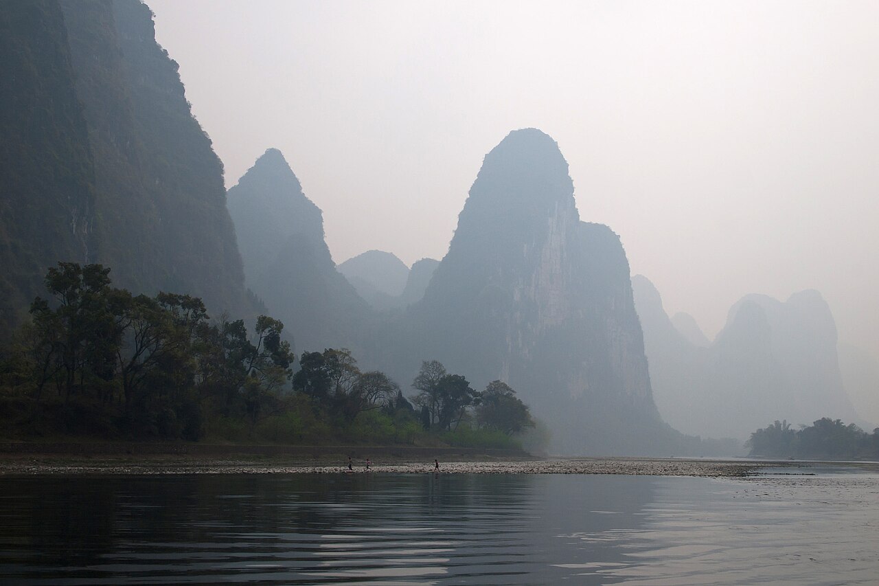 Misty karst peaks rising from the Li River at dawn